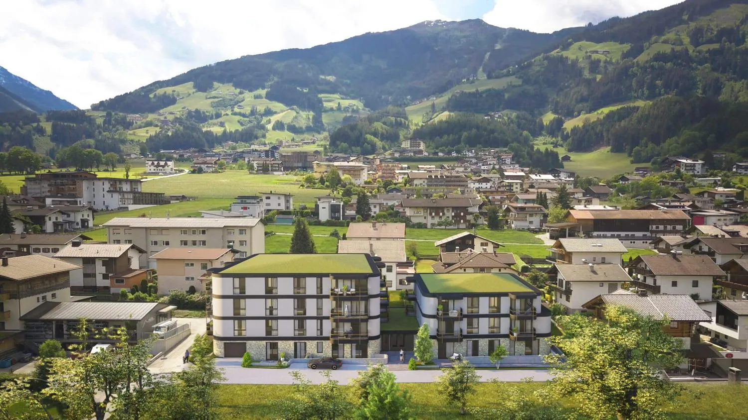 Ferienpark aus der Luft mit modernen Gebäuden, Grünflächen und Zillertal