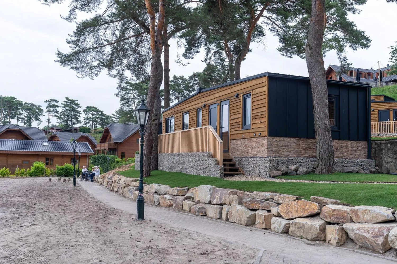 Ferienhaus-Gebäude mit Holzfassade und Natursteineinfassung